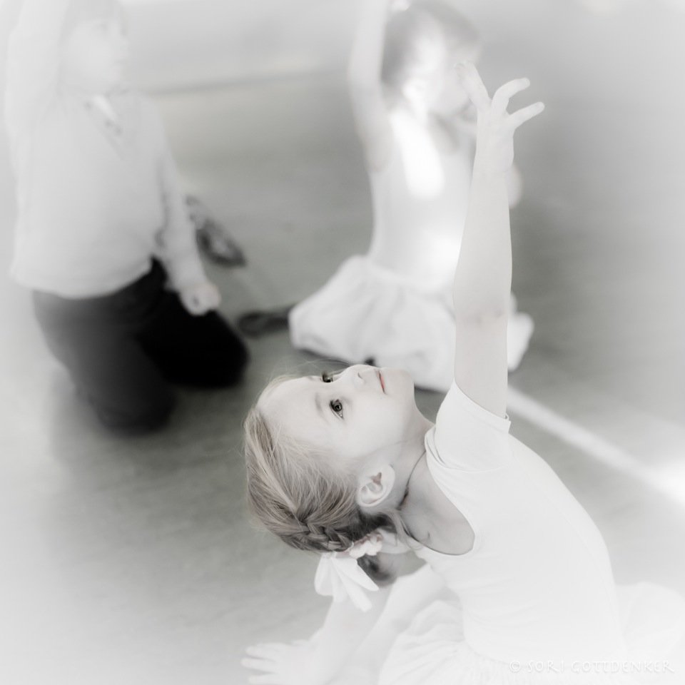 Photo by in house photographer Sori Gottdenker of a 3 year old pre ballet student in the dance studio practicing reaching with her arm and "Star Picking"